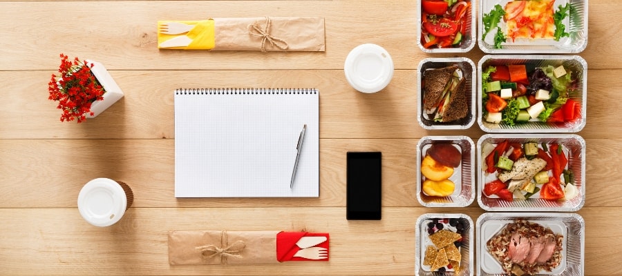 Prepared food around a notebook